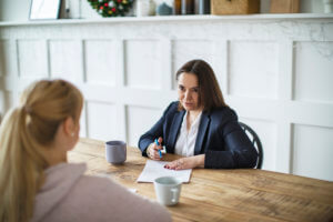 Woman sitting with family law attorney