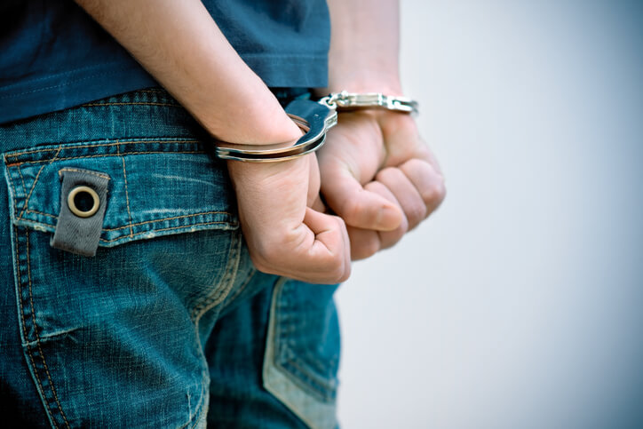 Child wearing handcuffs