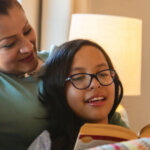 Mother sitting with child reading a book