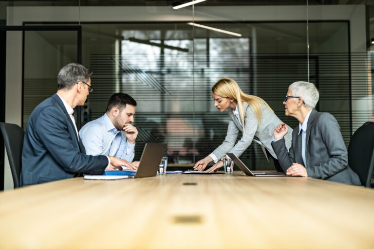 Business people at a conference table arguing