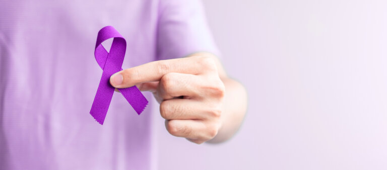 Man holding purple ribbon for domestic violence awareness